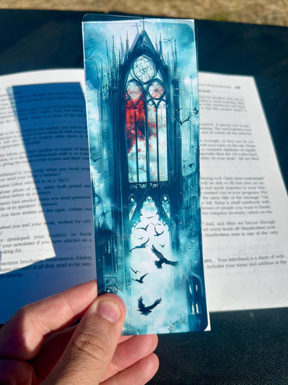 Decorative bookmark with a gothic design held over a book.