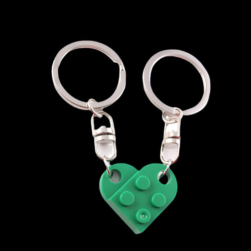 Green heart-shaped keychain with silver ring on a white background