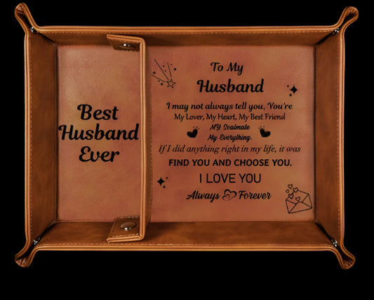 Brown leather tray with engraved message and keychain on a white background