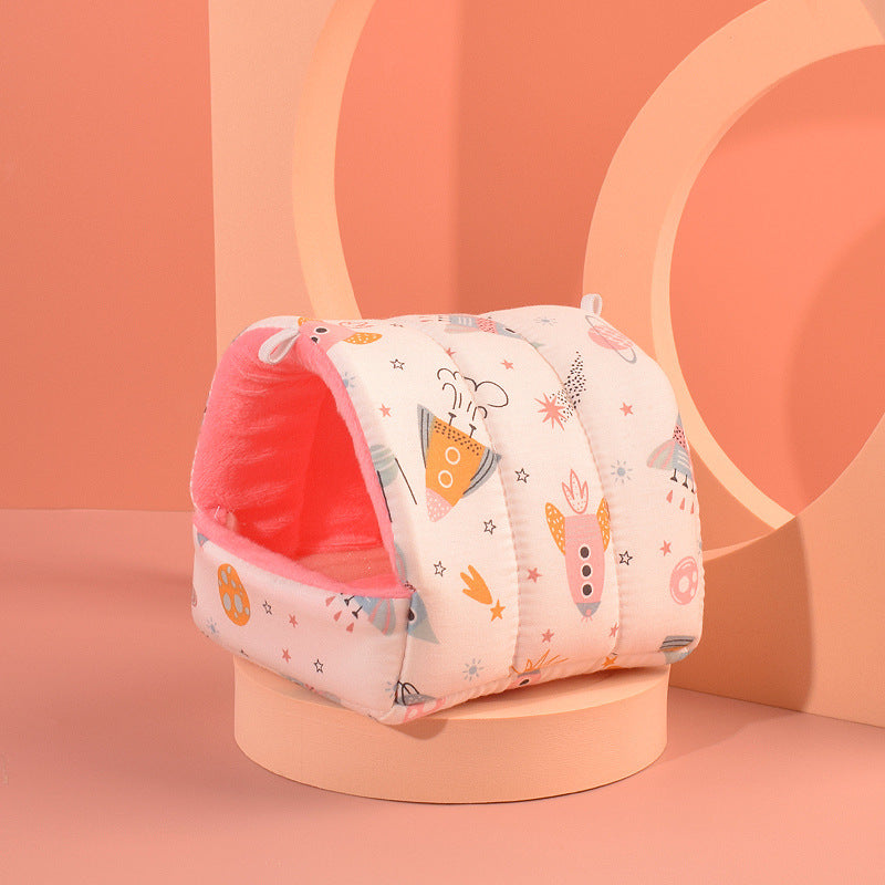 Baby seat with cartoon design on a pink stand against an orange background