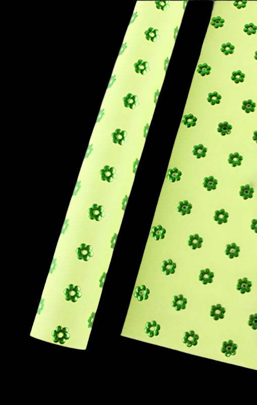 Green floral pattern on a light green background