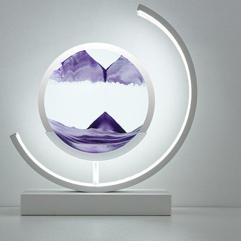 Decorative lamp with purple mountain design inside a circular frame on a gray background