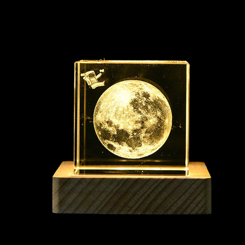 Decorative moon lamp with a spacecraft on a dark background
