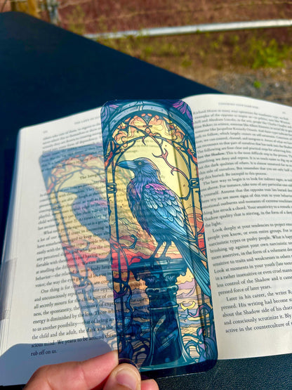 Colorful bird-themed bookmark on an open book outdoors