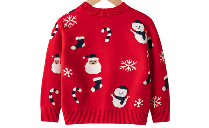 Red sweater with Christmas patterns on a wooden hanger against a white background