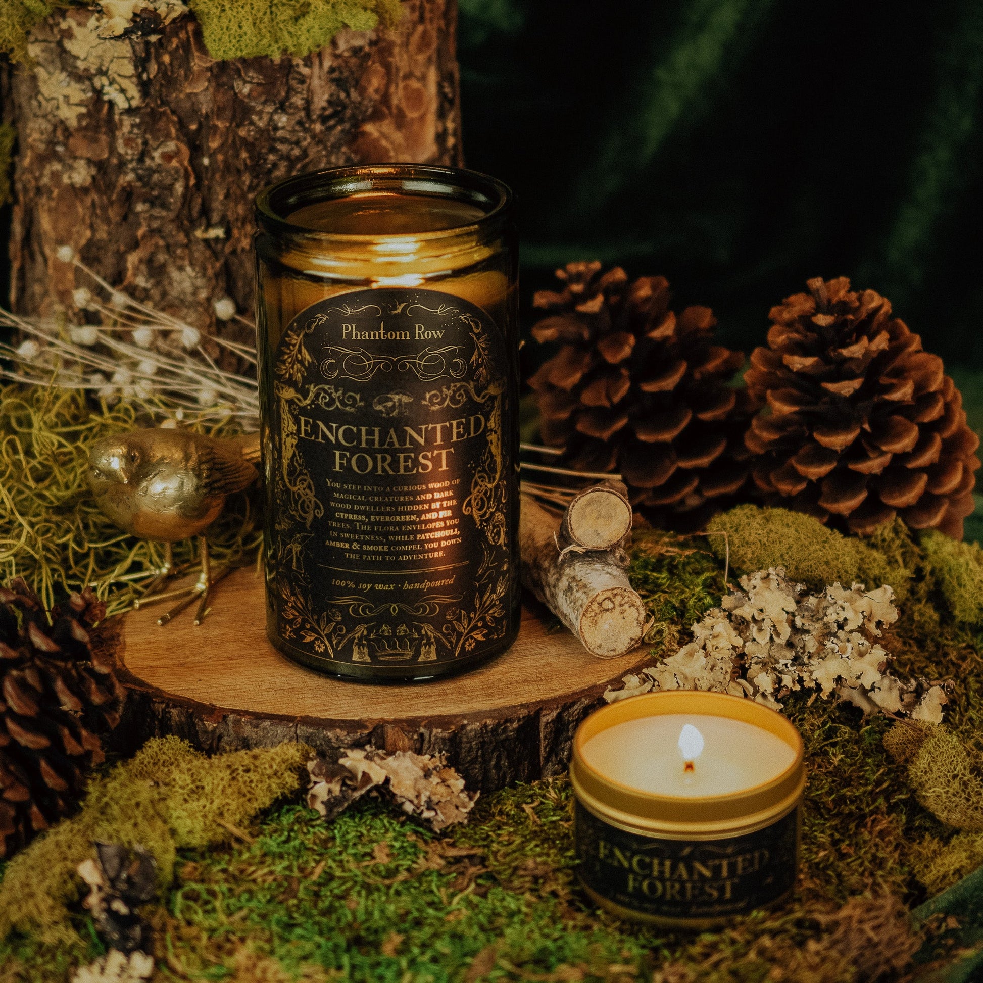 Enchanted Forest candle on a wooden stump with pine cones and moss in the background