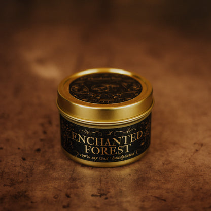 Candle jar labeled 'Enchanted Forest' with a gold lid on a textured brown background