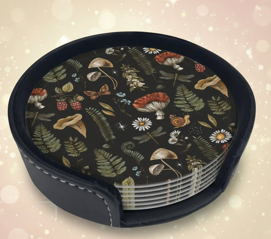 Set of coasters with a nature-themed design in a black holder