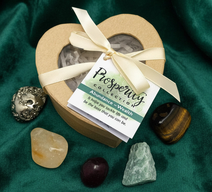 Heart-shaped box with stones and a tag labeled 'Prosperity Collection' on a white background