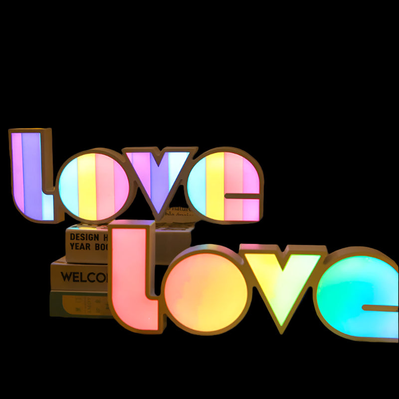 Colorful 'LOVE' sign with rainbow gradient on a dark background