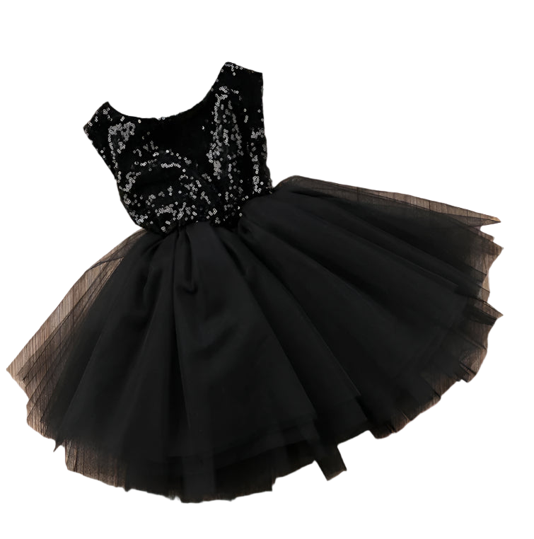Black sequin dress with a tulle skirt on a wooden surface
