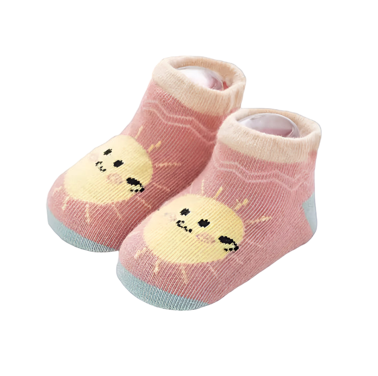 Pair of baby socks with smiley face design on a light background