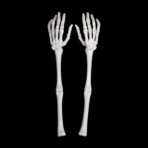 Two skeleton hand spoons on a black background
