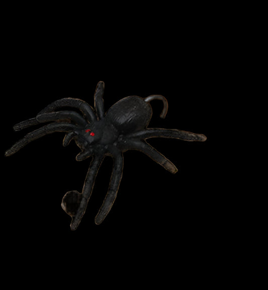 Black spider toy on a wooden surface