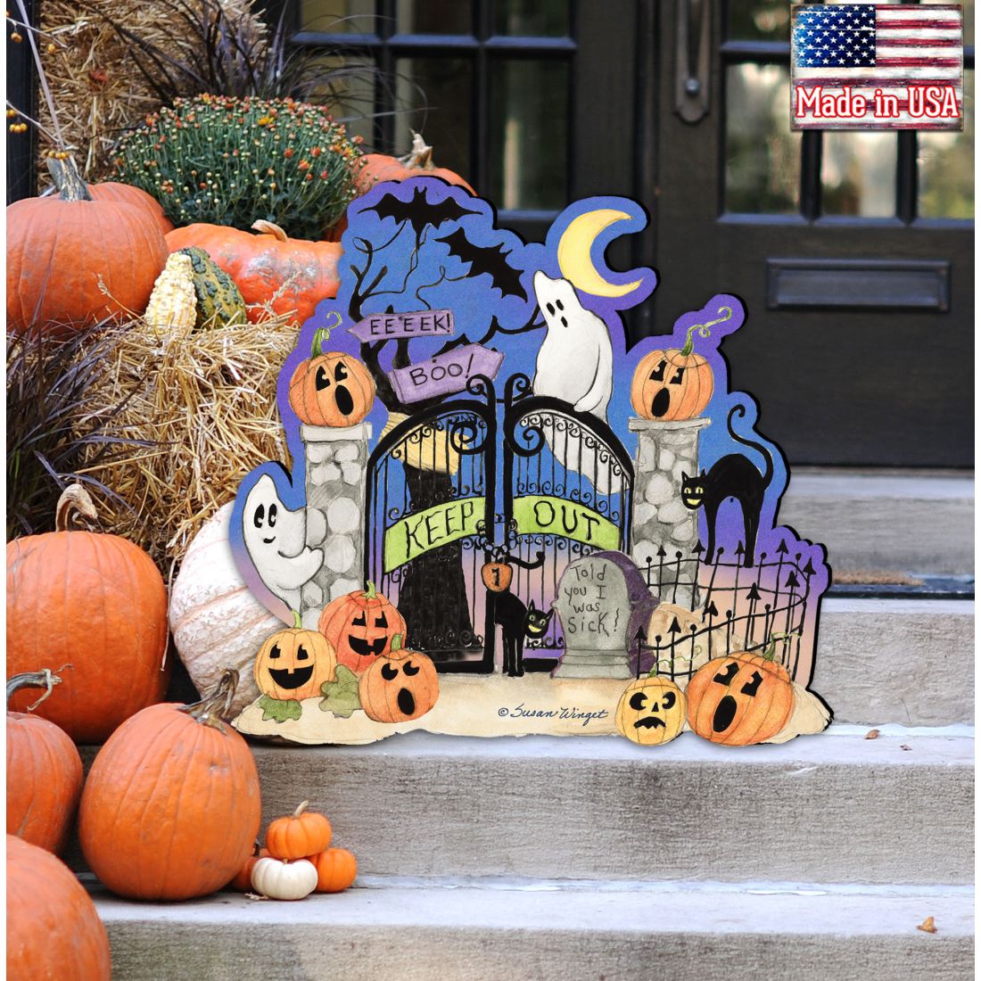 Halloween-themed decorative sign with pumpkins and ghosts on a porch.