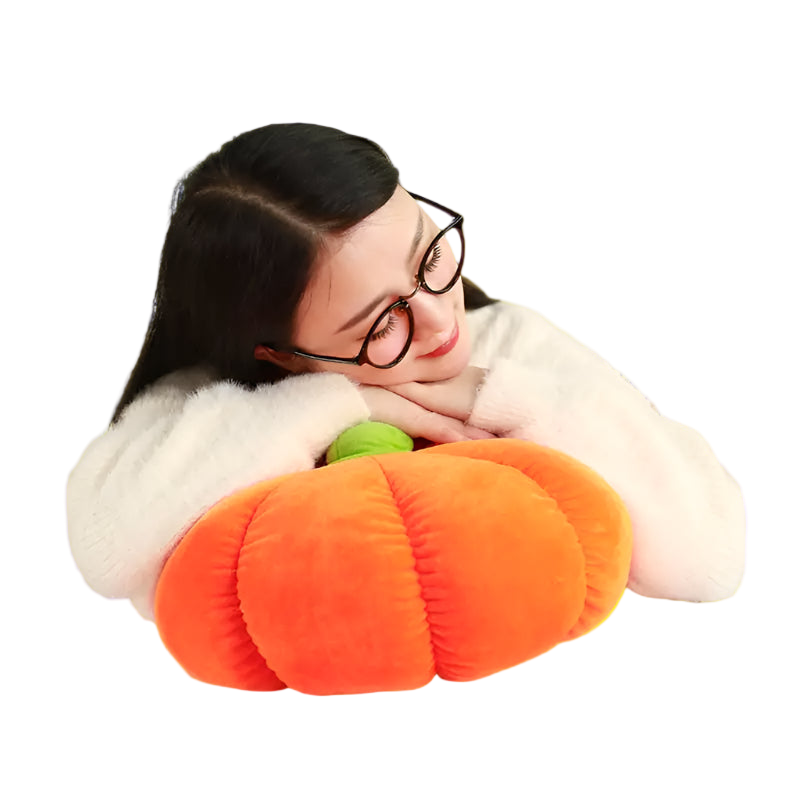 Person lying on a checkered floor with a large orange plush pumpkin pillow.