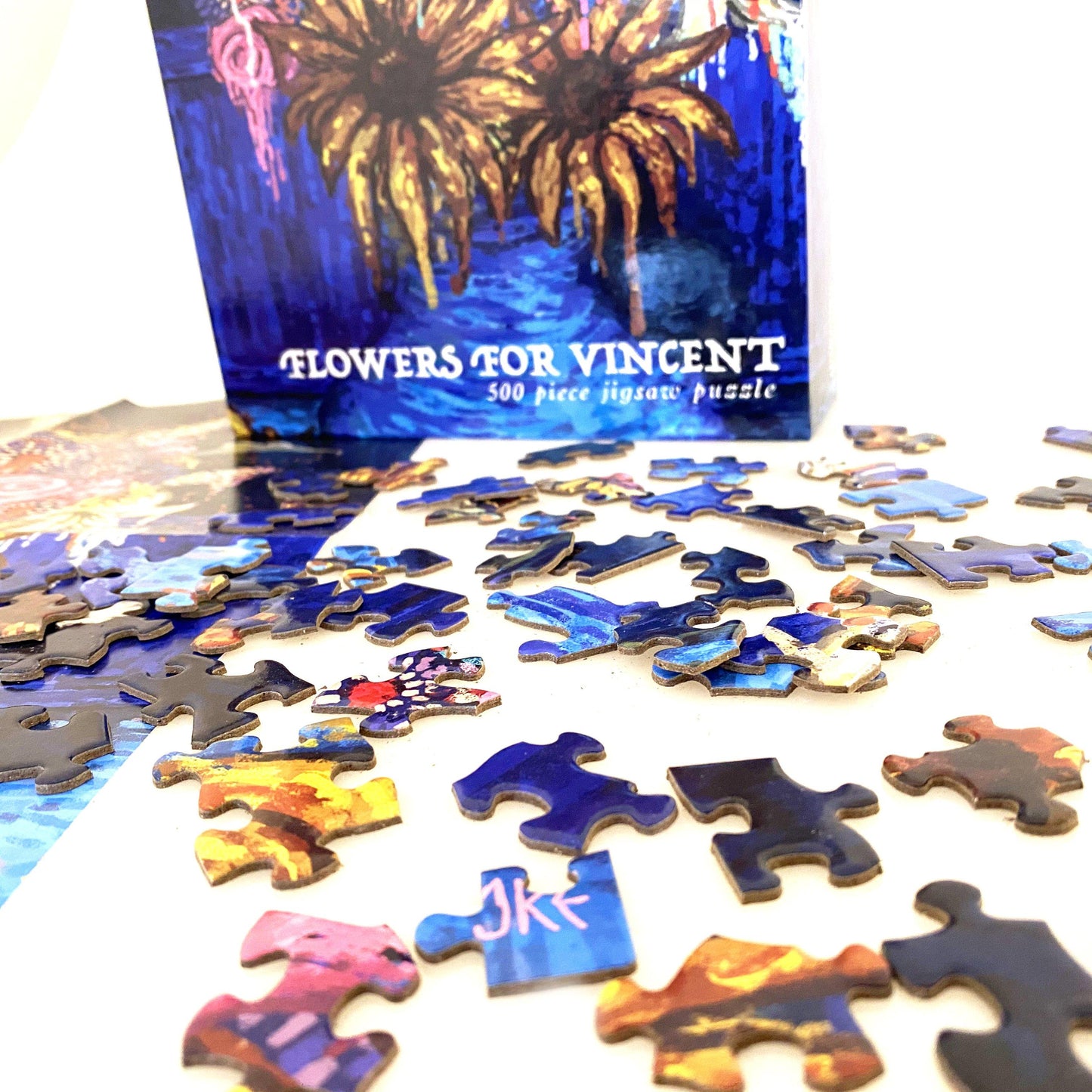 Jigsaw puzzle pieces with 'Flowers for Vincent' box in the background