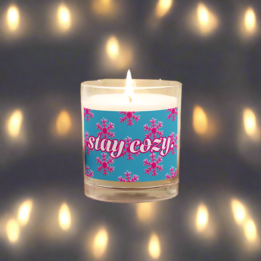 Candle with a pink and blue snowflake 'stay cozy' label 