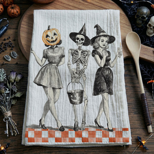 Halloween-themed towel with skeletons and pumpkins on a wooden surface.
