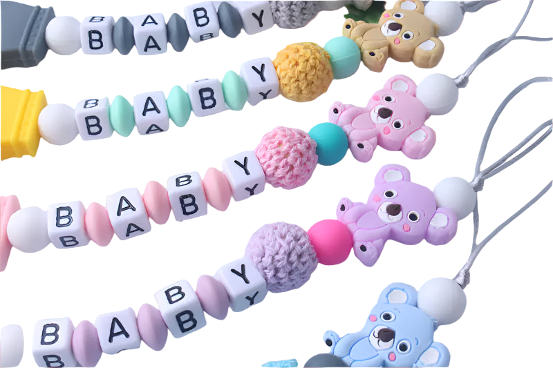 Colorful baby necklace with teddy bear charms on a white background