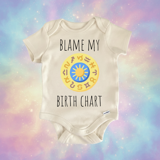 Beige baby onesie with text 'BLAME MY BIRTH CHART' and a circular design on a white background