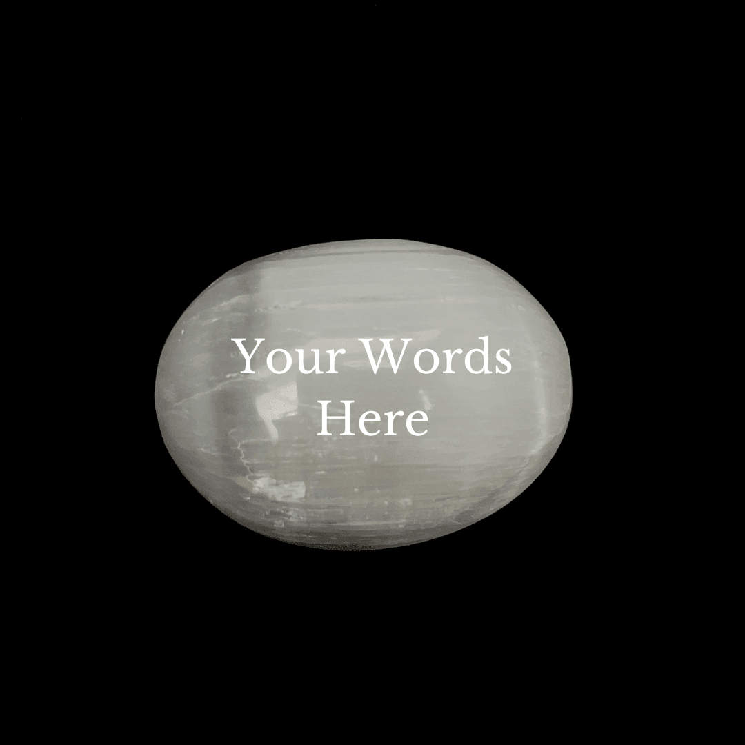 A polished white stone oval with the text 'Your Words Here' printed in white on the front, set against a solid black background.