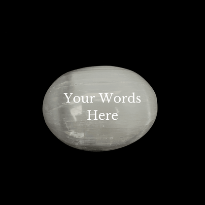 A polished white stone oval with the text 'Your Words Here' printed in white on the front, set against a solid black background.