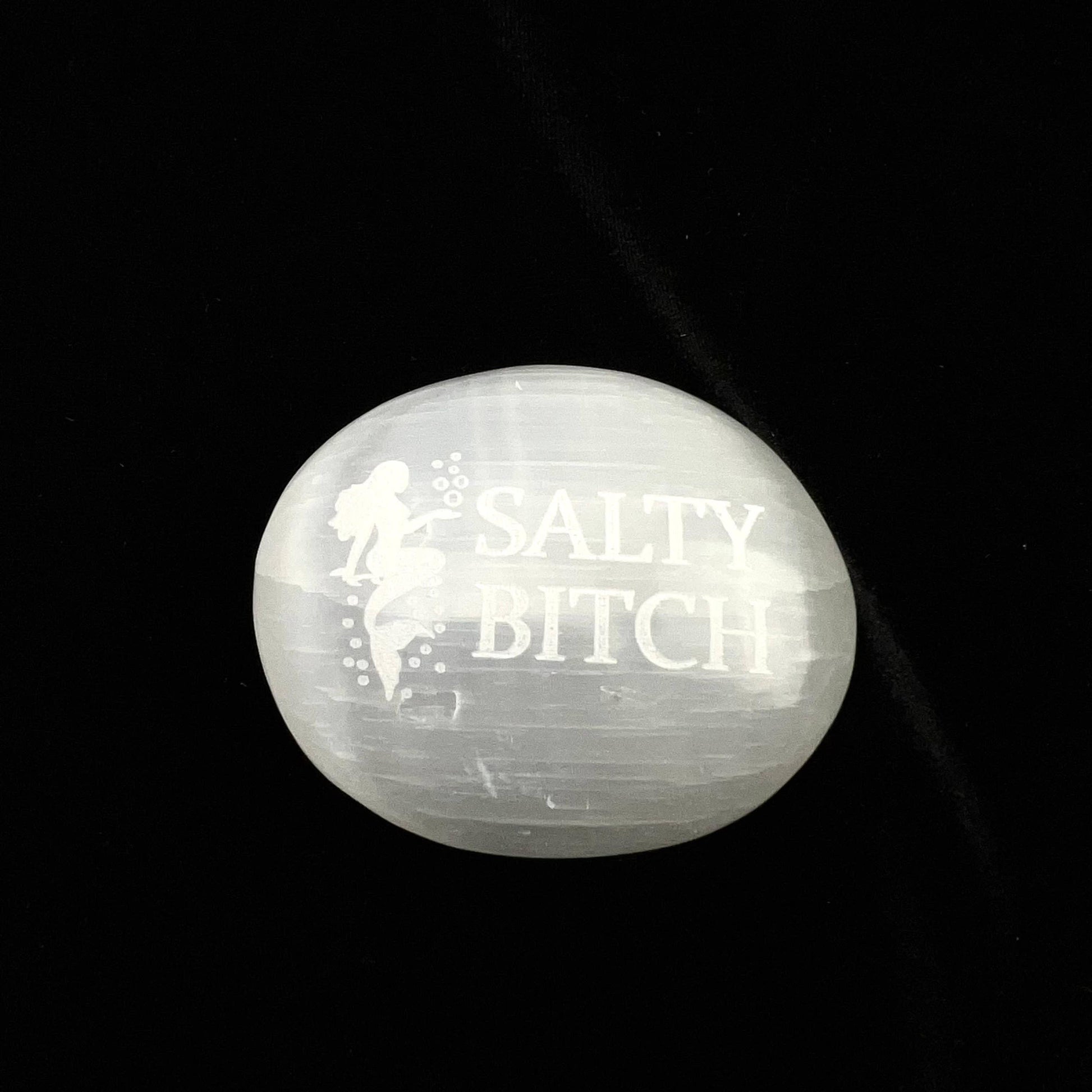 Round stone with 'SALTY BITCH' engraved on a black background