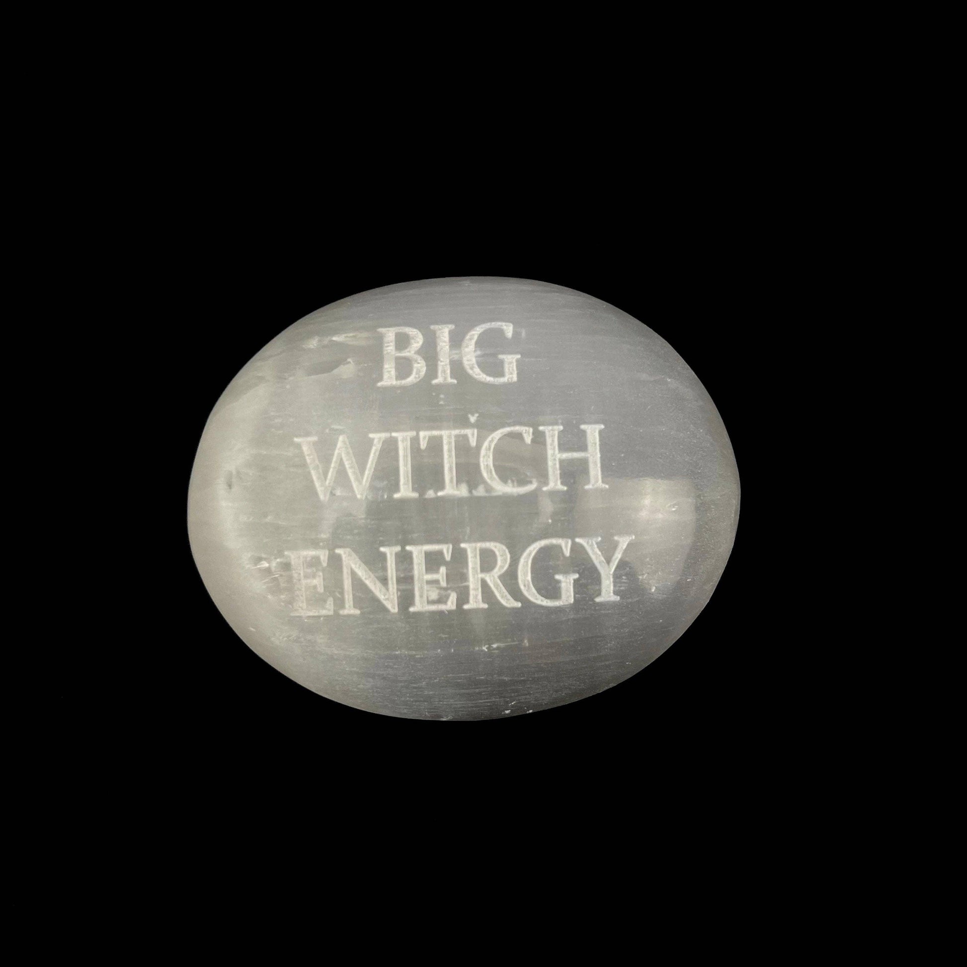 Round stone with 'BIG WITCH ENERGY' text on a black background
