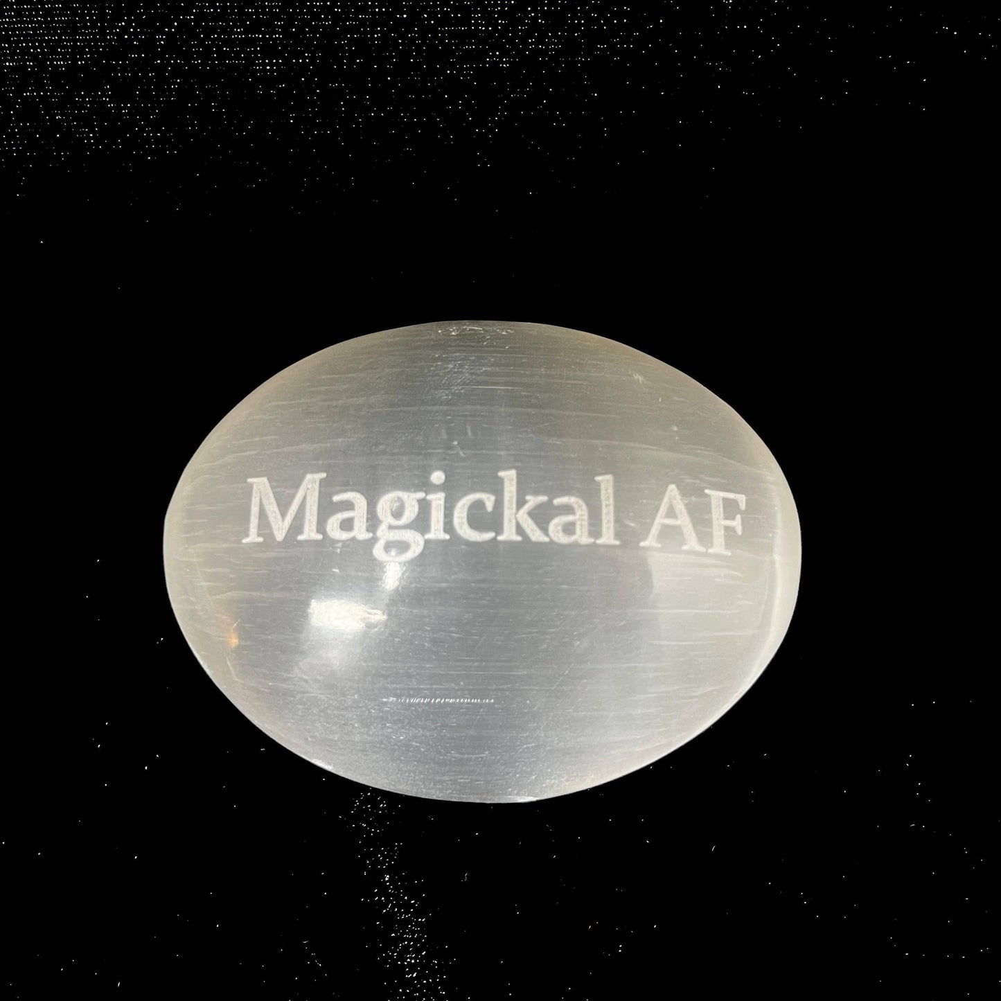 Clear crystal with 'Magickal AF' text on a black background