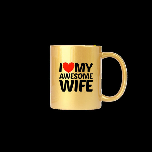 Gold mug with 'I ❤️ MY AWESOME WIFE' text on a white surface with a plant and keyboard in the background.