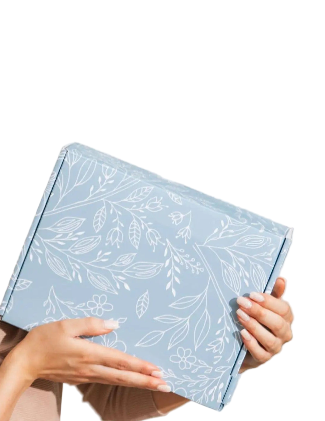 Woman holding a blue gift box with floral patterns, text 'Perfectly Packaged. Ready to Gift' above.