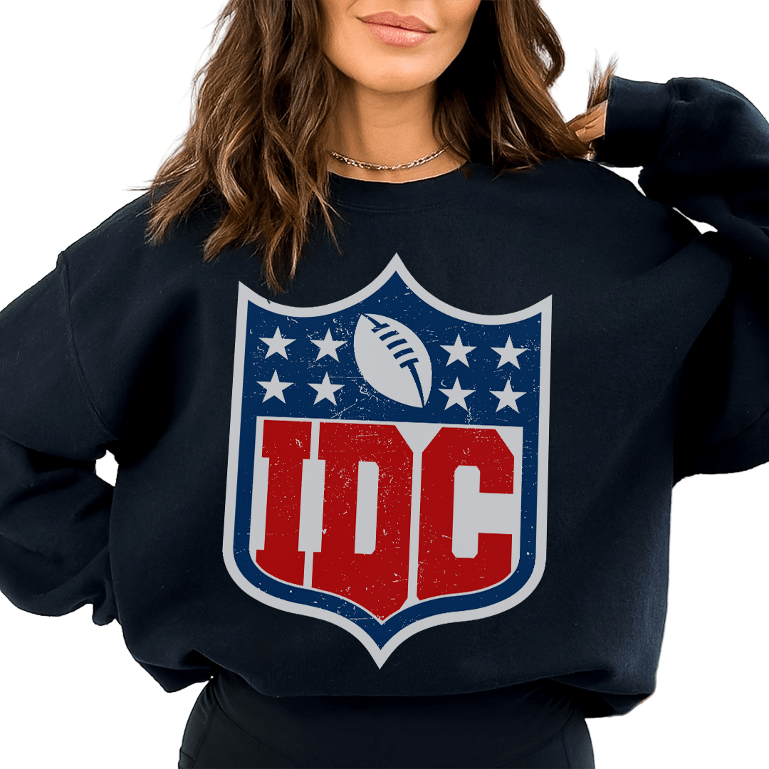 Person wearing a black sweatshirt with a red and blue logo on a white background