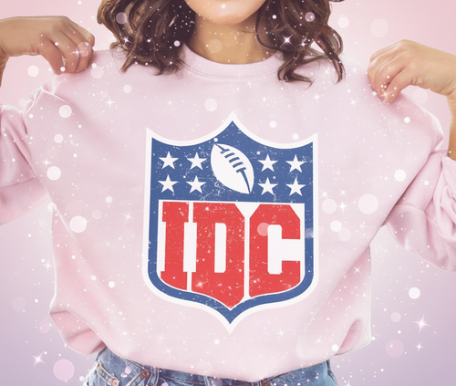 Person wearing a pink sweatshirt with a logo featuring 'IDC' letters.