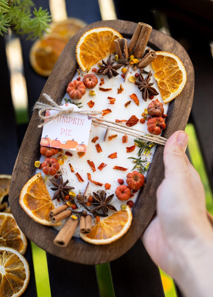 Spice blend with oranges, cinnamon, and star anise on a wooden board.