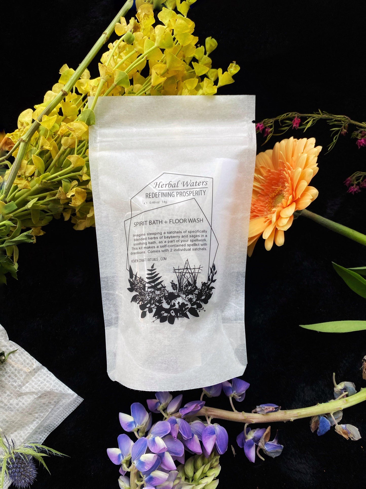 White product packaging with botanical design surrounded by flowers on a dark background