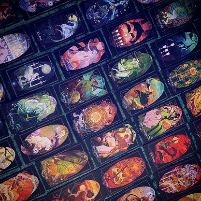 A close-up, angled view of a deck of illustrated tarot cards arranged in a grid. The cards feature highly detailed, colorful fantasy and mythological artwork on dark backgrounds, with teal borders separating the cards.