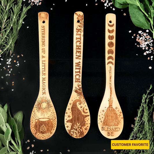 Three wooden spoons with engraved designs and text on a black background with herbs.
