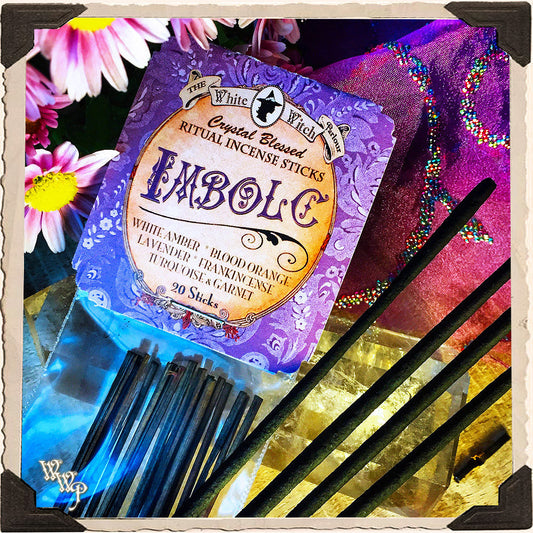 Pack of Incense Sticks with colorful packaging and flowers in the background
