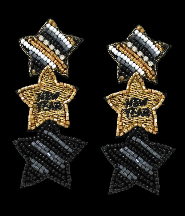 Star-shaped earrings with black, gold, and white beads on a white background