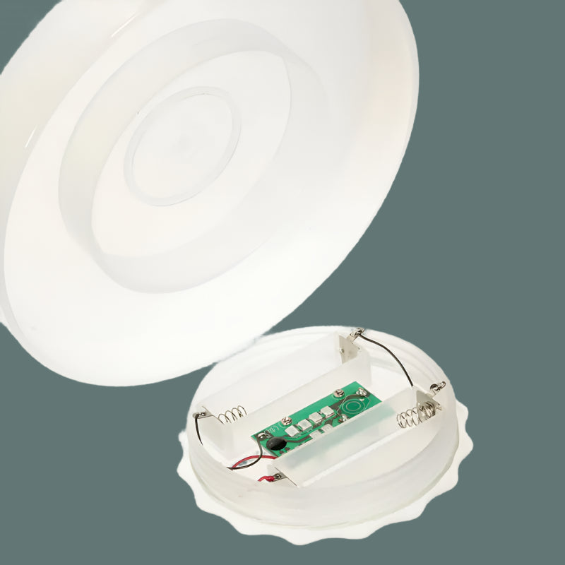 Close-up of a white electronic device with a circuit board on a white background