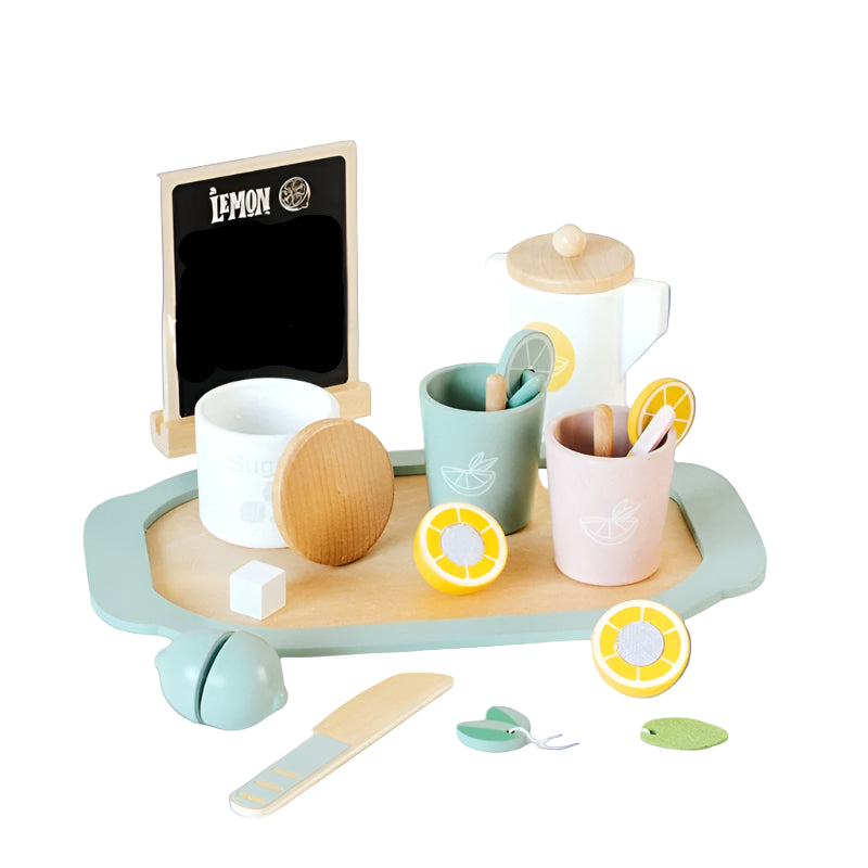 Children's play kitchen set with cups, tray, and lemon decorations on a white surface.