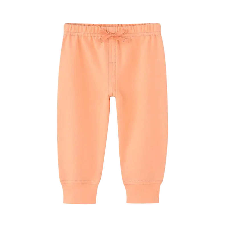 Peach-colored sweatpants on a white background
