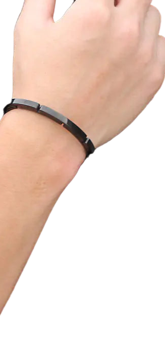 Person wearing a black bracelet on a plain background