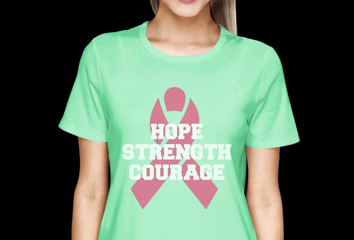 Person wearing a green t-shirt with a pink ribbon and text 'Hope Strength Courage' on a white background