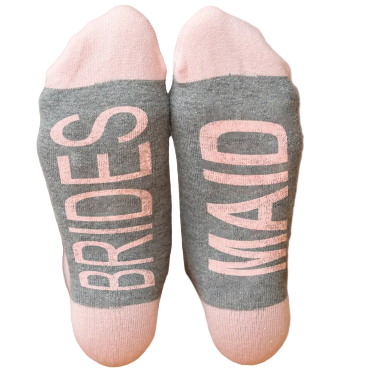 Gray socks with 'BRIDES' and 'MAD' text in pink on a wooden floor.