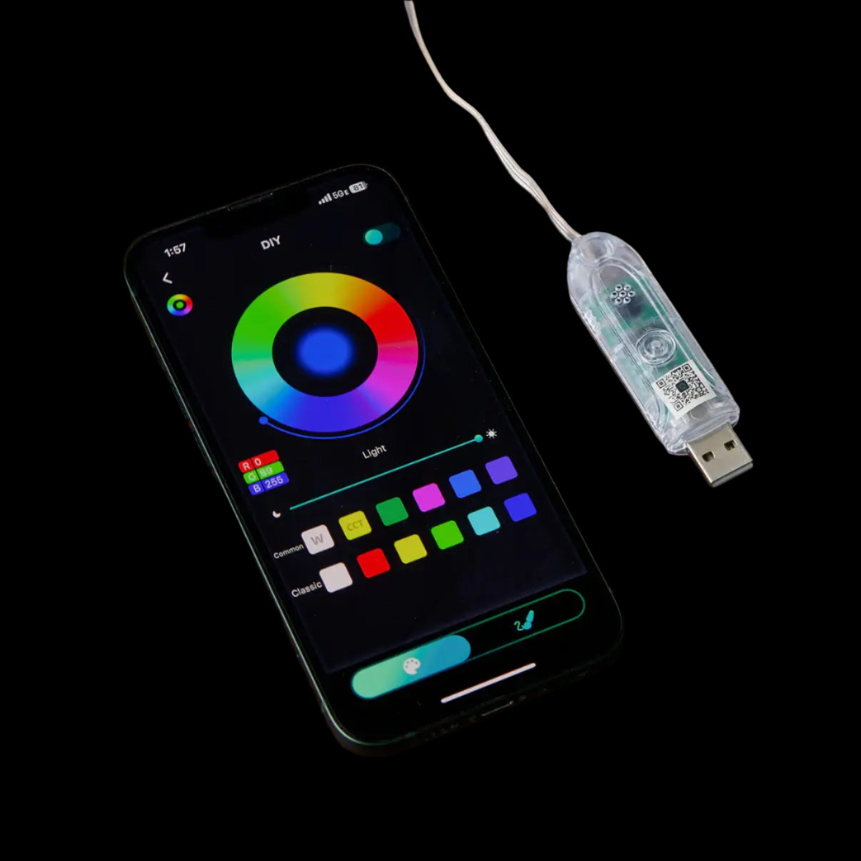 Smartphone with color wheel app and USB adapter on a wooden surface