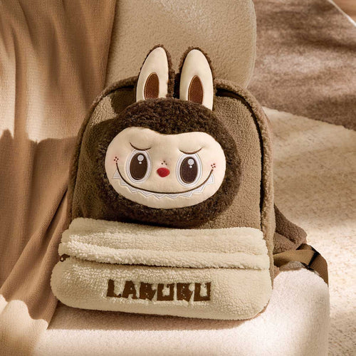 Plush labubu backpack with cartoon face design on a soft beige background