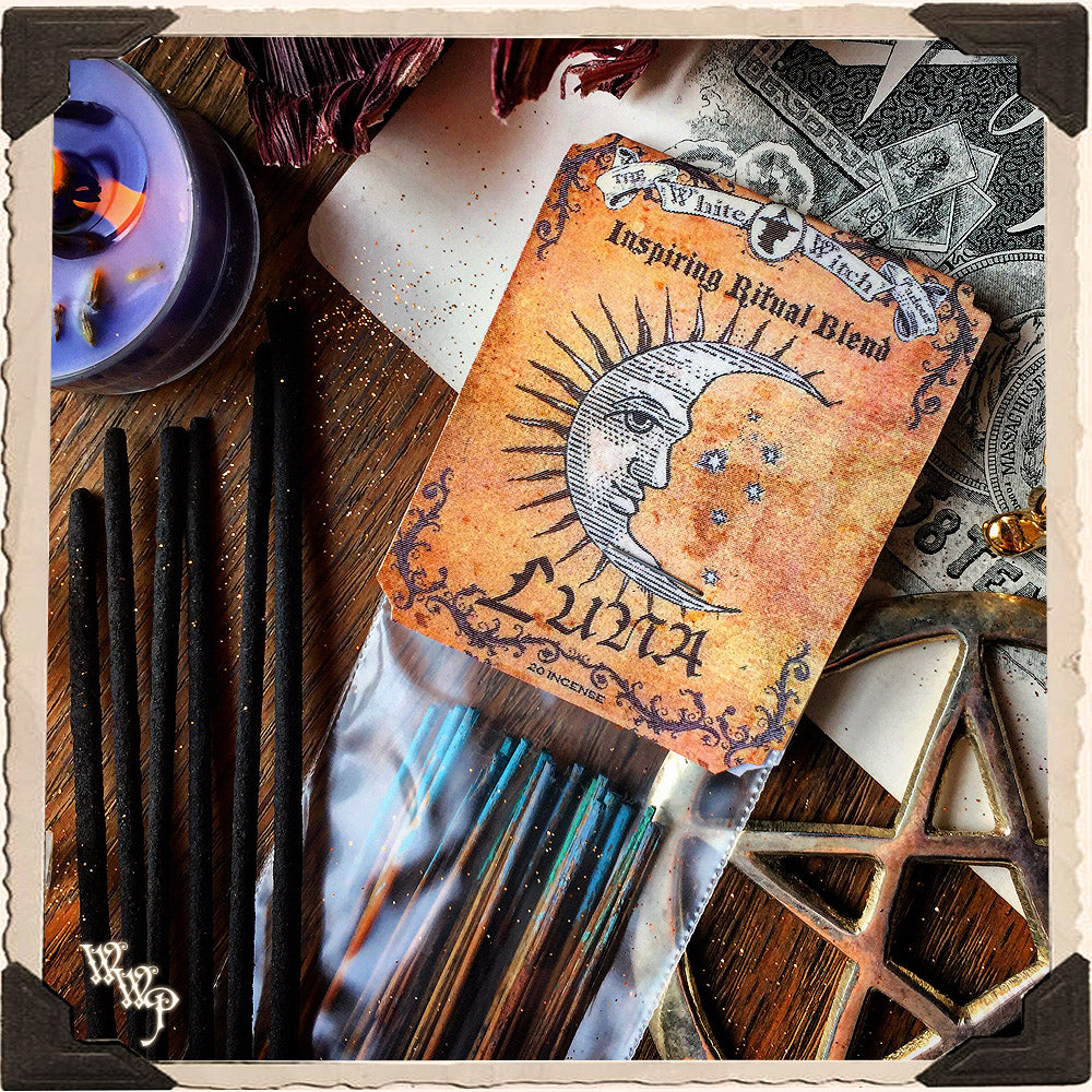 Wand with 'Luna' label surrounded by candles and wands on a wooden surface