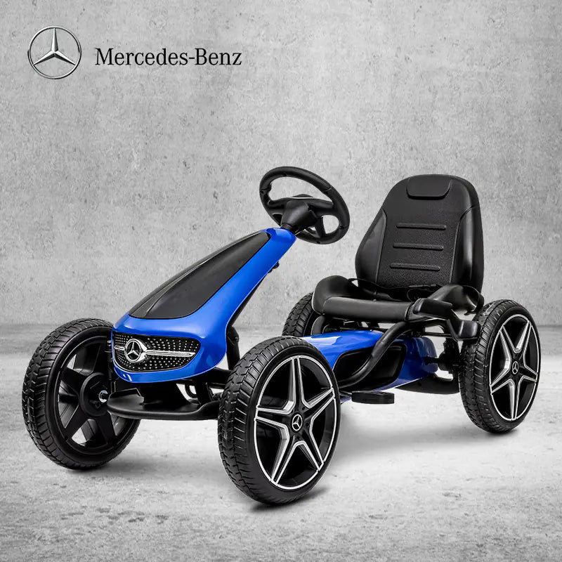 Blue and black Mercedes-Benz pedal car on a gray concrete floor.